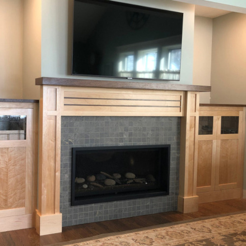 Custom woodwork fireplace surround and cabinets